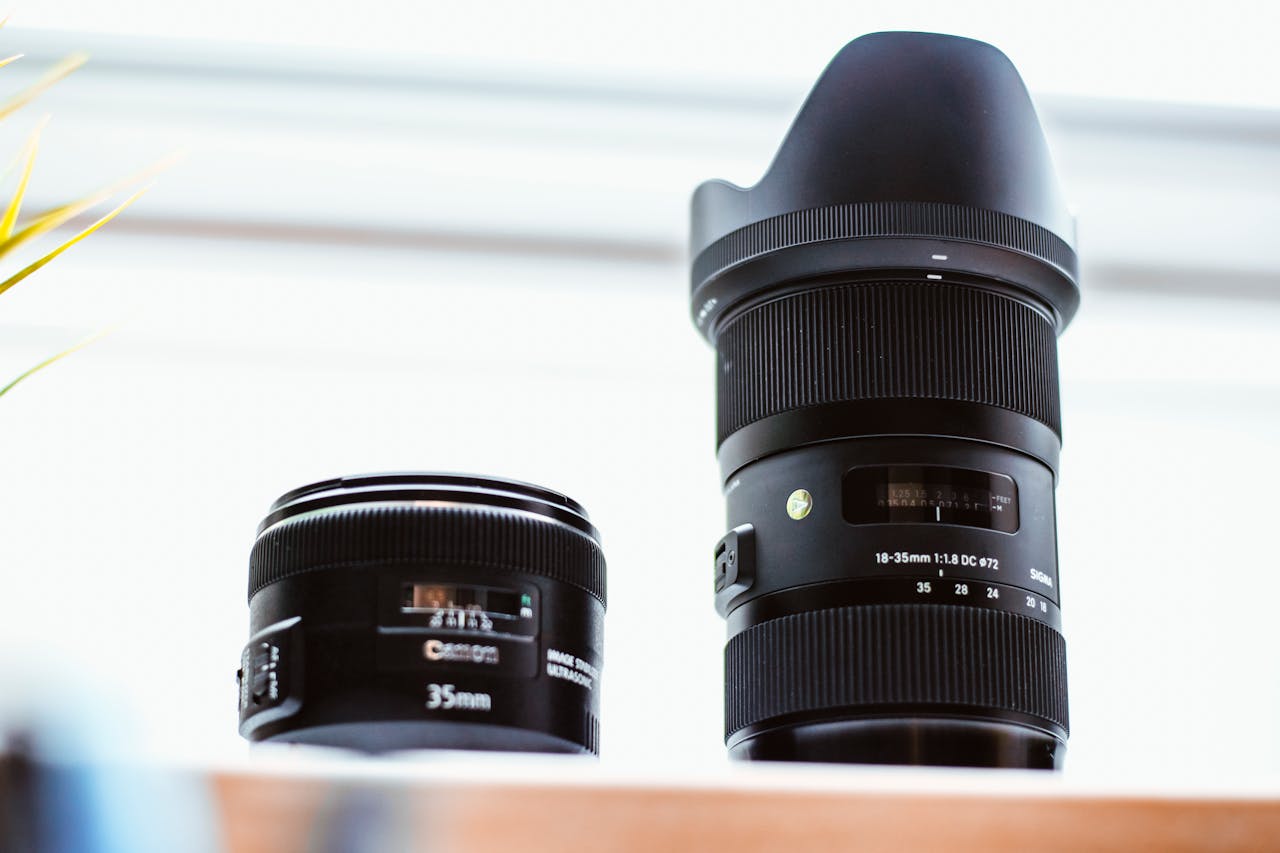 Two different types of camera lenses side by side in a well-lit setting.