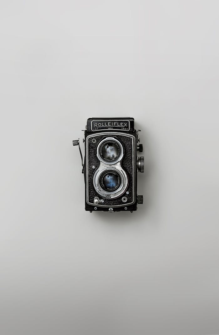 Classic Rolleiflex camera showcased against a simple background, emphasizing nostalgia and vintage design.